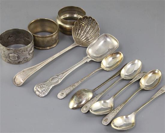 Six silver coffee spoons, a Victorian silver sifter spoon, a silver sorbet? spoon and three silver serviette rings.